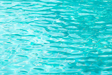 Ripple Water in swimming pool with blue tile floor background