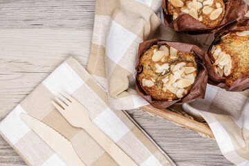 Banana Nut Muffins resting on a wooden table