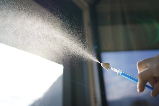 Nebulizing a drug for intranasal application with a mucosal atomization device on a syringe. 