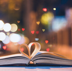Heart shaped book on a background made of hearts