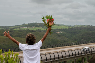 Excited young boy with proteas in hand
