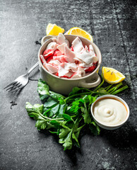 Crab meat with parsley, lemon slices and sauce.