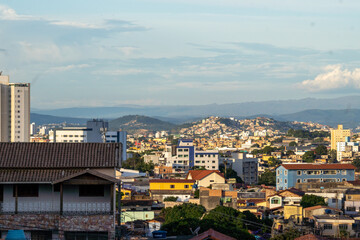 Fototapeta premium Amazing metropole with houses on small hills and horizon with mountains