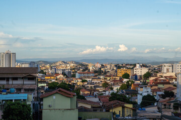 Amazing metropole with houses on small hills and horizon with mountains