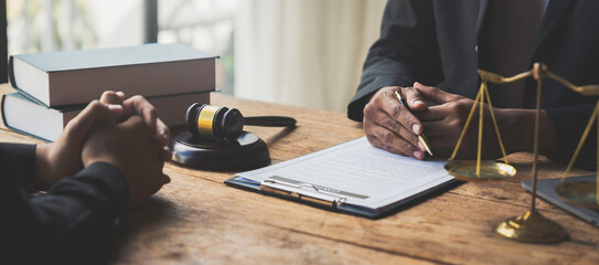 A young Asian lawyer or legal advisor clarifies information about business deals. The signing of investment contracts in accordance with laws and regulations.