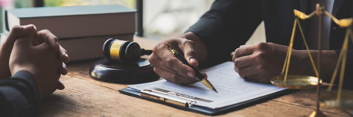 A young Asian lawyer or legal advisor clarifies information about business deals. The signing of investment contracts in accordance with laws and regulations.