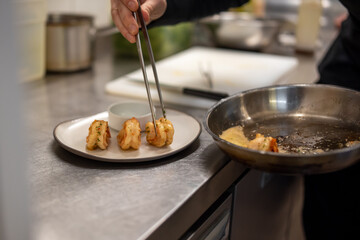 man chef cooking fried shrimp on kitchen