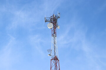 mast in the field with antennas , communication tower