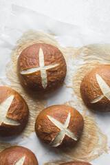 Pretzel buns on a baking sheet, German laugenbroetchen, lye buns on a baking tray