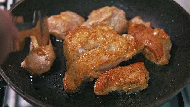 Close up footage of preparing chicken meat in frying pan.