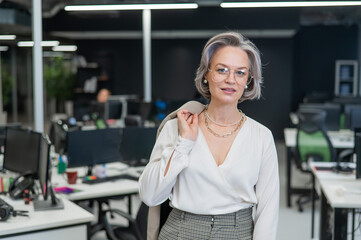 Portrait of an attractive mature caucasian woman in the office. 