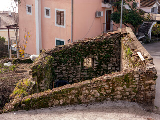 Ruined house without roof with stone walls top angle view
