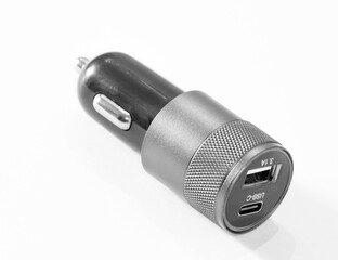 Black USB electronics device car charger isolated on white .