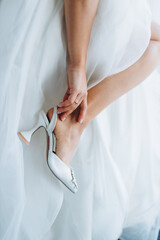 Young women in stylish shoes on color background