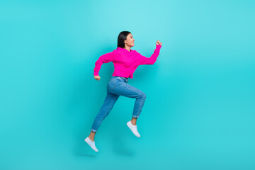 Fototapeta na wymiar Full length photo of sweet adorable lady wear pink sweater running fast jumping high isolated turquoise color background