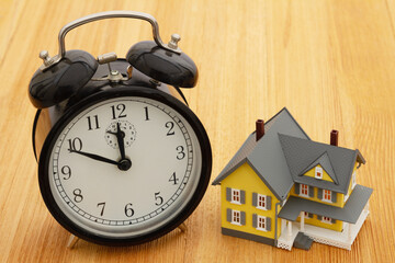 Time to purchase real estate with clock and a house