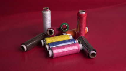 Multicolor sewing threads on background