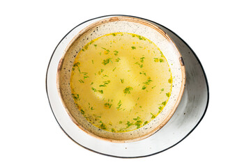 Appetizing golden broth with herbs in a bowl. Traditional homemade dish. Isolated on white background.
