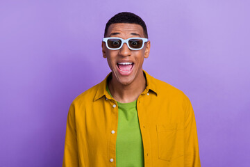 Portrait of ecstatic overjoyed handsome guy wear yellow clothes glasses astonished staring open mouth isolated on pastel color background