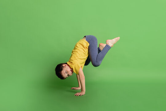 Kid doing handstand in studio