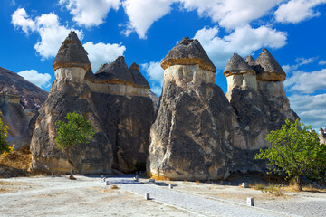 Picturesque natural stone statues against the blue sky in Cappadocia. Goreme National Park, district of Nevsehir, Kapadokya, Turkey