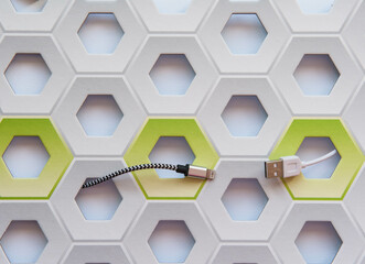 White and black cable connectors micro-USB to USB on white and green honeycomb background