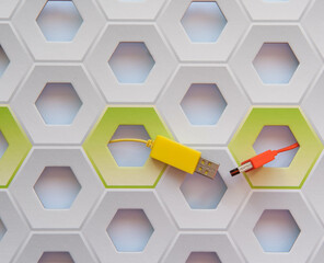 Orange and yellow cable connectors micro-USB to USB on white and green honeycomb background