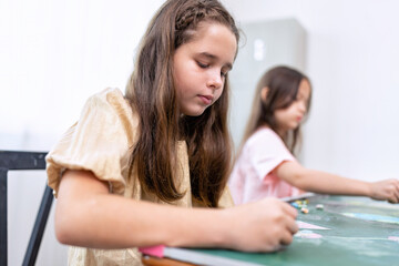 Children in class room happy laughing enjoy draw picture on green board