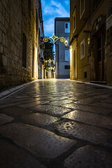 cobblestone alley with christmas lights