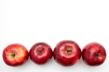 Row of Red apples on a white background