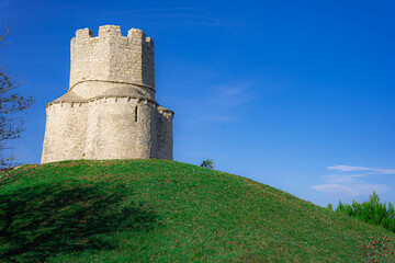Fototapeta na wymiar Fortress on green hill with blue sky