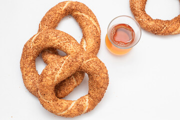 Turkish bagel simit and tea on white background.