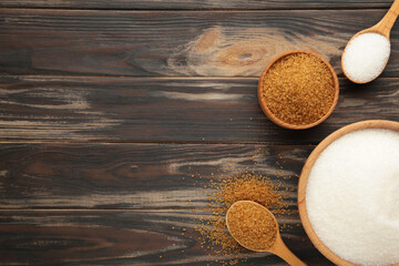 White and brown sugar in bowl on brown background. Space for text
