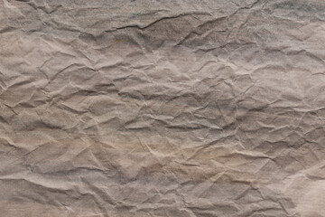 Background in faded washed-down colors with a graphic crumpled surface. Texture, paper, grunge.       