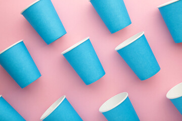 Paper disposable cup on pink background.