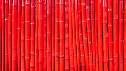 The background texture of the bamboo fence wall, which is plastered with red oil paint.