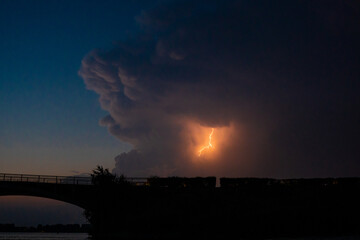 Lightning bolt in clouds before storm