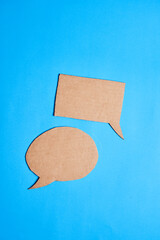Square and circular dialogue bubbles made of cardboard, concept communication, togetherness,...
