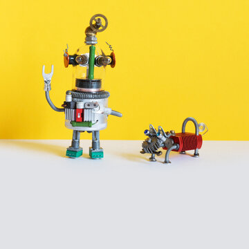 Robot dog brought the key to the owner. Yellow gray background, copy space