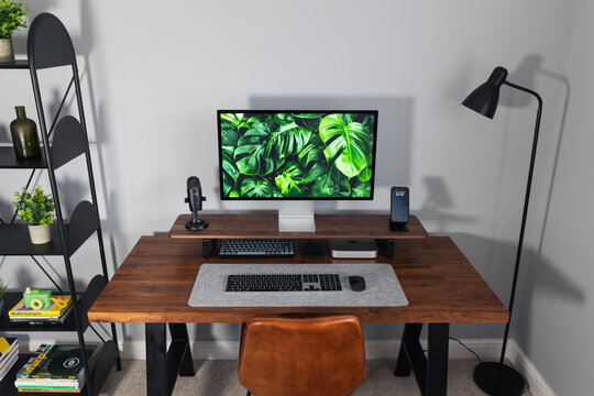 LONDON - NOVEMBER 23, 2022: Minimal desk setup with Apple Mac Mini computer in modern work from home office