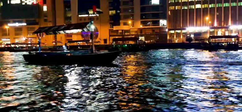 Footage of traditional arabic boats , abras crossing the creek. Outdoors