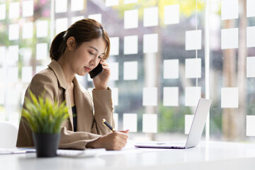 Fototapeta premium Serious business woman working in the office.