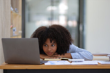 African woman sleepy at work time and exhausted from overwork in the office.