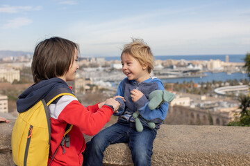 Cute little children tourists admiring Barcelona city, family travel with kids