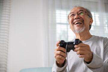 Funny retirement elderly smile sitting on sofa life gaming, lifestyle senior old man enjoying...