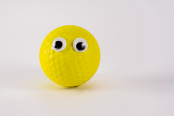 funny yellow ball character with googly eyes isolated on a white background