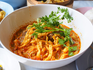 Northern style curried noodle soup with chicken closeup view