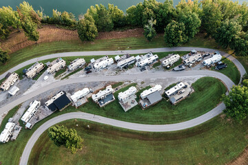 Aerial drone overhead view of an RV motor home camp site, marina boat storage and camp grounds on...