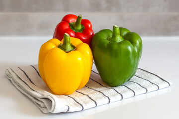 red yellow green sweet pepper on kitchen towel colorful paprika