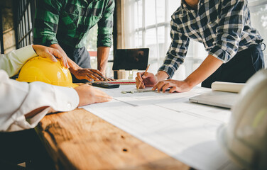 Engineers work as a team with blueprints for architectural plans. Engineer sketching construction project concept with architect equipment Architects talking at table Teamwork and construction concept